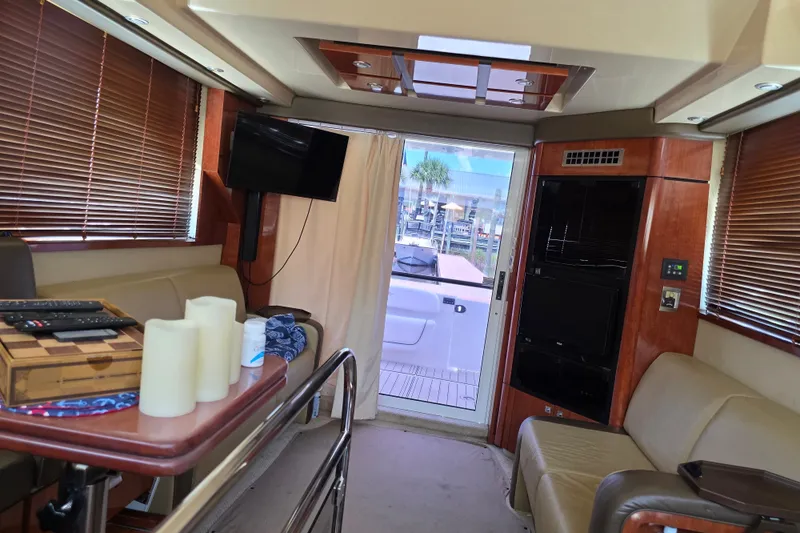 Slide: The Image of Interior of 2007 Sea Ray 36 Sedan Bridge yacht with seating, TV, and decor. - 8