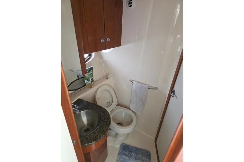 Slide: The Image of 2007 Sea Ray 36 Sedan Bridge bathroom with sink, toilet, and storage cabinets. - 11
