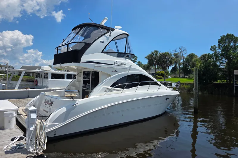 Slide: The Image of 2007 Sea Ray 36 Sedan Bridge yacht docked on a sunny day. - 2