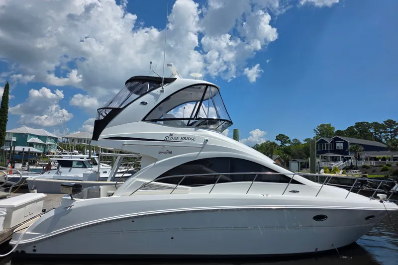 The Image of 2007 Sea Ray 36 Sedan Bridge yacht docked under a clear blue sky. - 1