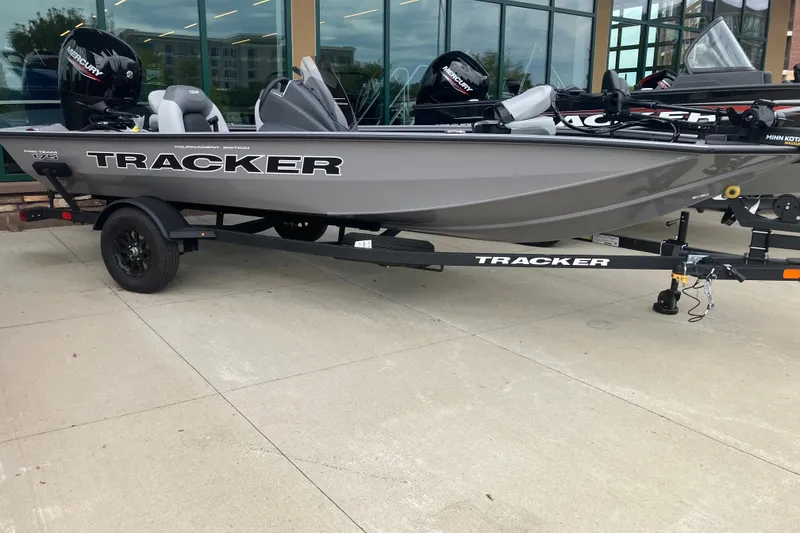 The Image of 2027 Tracker Pro Team 175 boat on trailer, displayed outdoors. - 0