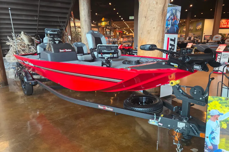 The Image of 2027 Tracker Bass Tracker Classic XL boat displayed indoors, featuring a vibrant red design. - 0