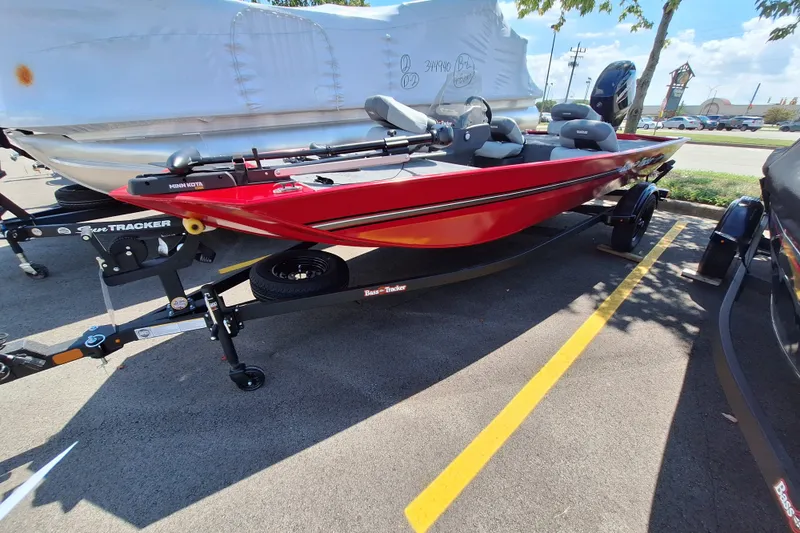 The Image of 2027 Tracker Bass Tracker Classic XL boat in vibrant red on a trailer, parked outdoors. - 0