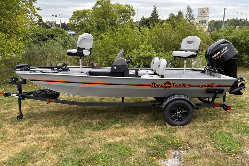 The Image of 2027 Tracker Bass Tracker Classic Limited boat on trailer, parked on grass. - 0