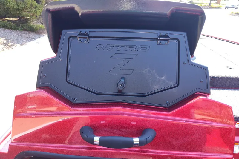 Slide: The Image of 2027 Nitro Z18 XL Pro boat storage compartment with open lid, red exterior. - 11