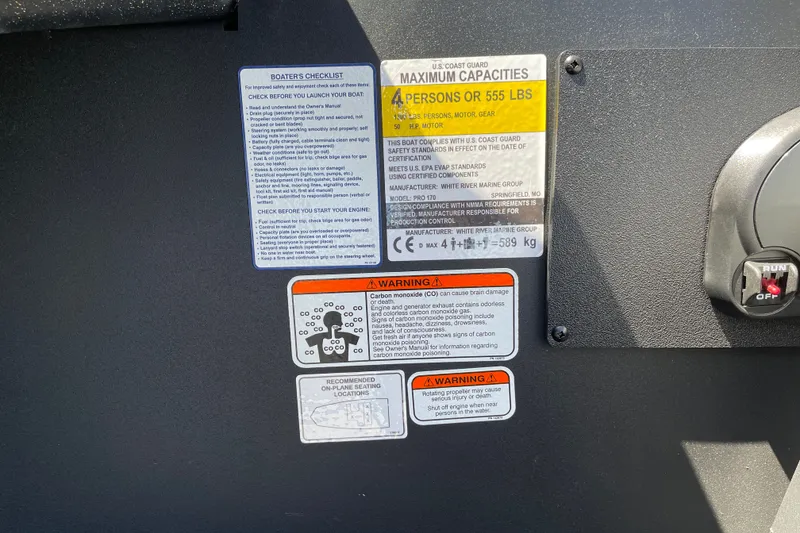Slide: The Image of Tracker Pro 170 boat safety labels and warnings, including capacity and carbon monoxide alerts. - 15