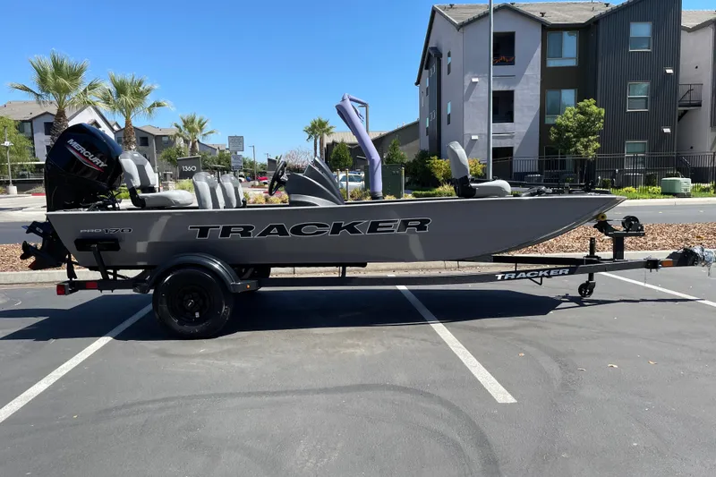 The Image of 2027 Tracker Pro 170 boat on trailer in parking lot, sunny day. - 0