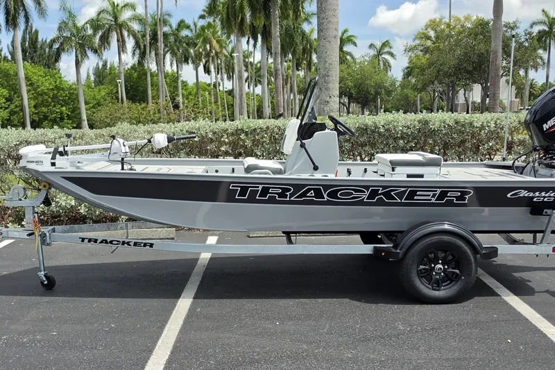 The Image of 2027 Tracker Bass Tracker Classic CC boat on trailer, parked with palm trees in background. - 0