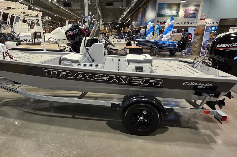 The Image of 2027 Tracker Bass Tracker Classic CC boat displayed indoors on a trailer. - 0