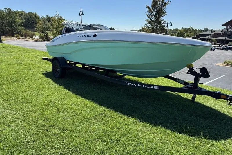 Slide: The Image of 2027 Tahoe T18 boat on trailer, parked on grass, sunny day. - 1
