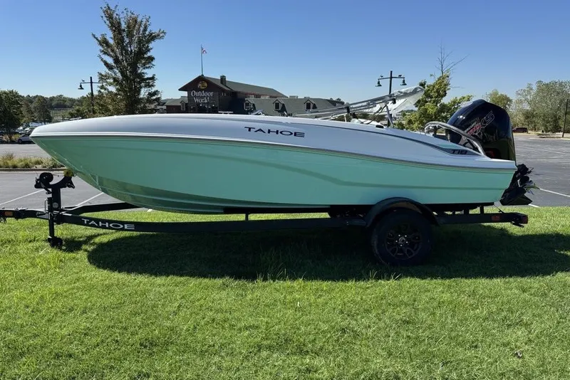 Slide: The Image of 2027 Tahoe T18 boat on trailer, parked on grass, with clear blue sky background. - 5