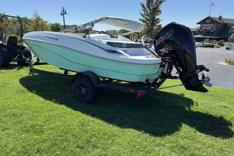 Slide: The Image of 2027 Tahoe T18 boat on trailer with powerful outboard motor, parked on grass. - 7