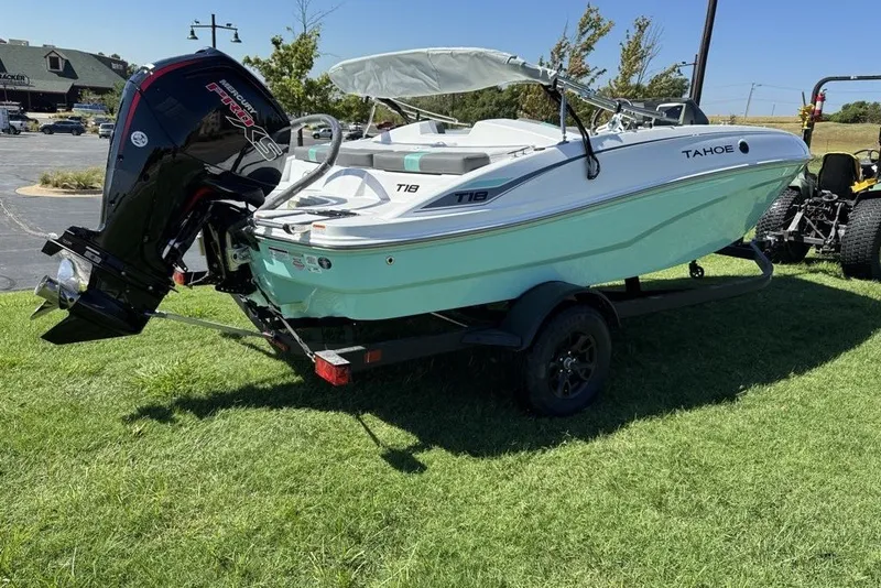 Slide: The Image of 2027 Tahoe T18 boat on trailer, parked on grass, with outboard motor. - 3
