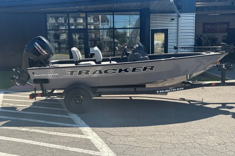 The Image of 2027 Tracker Super Guide V-16 SC boat on trailer outside dealership. - 0