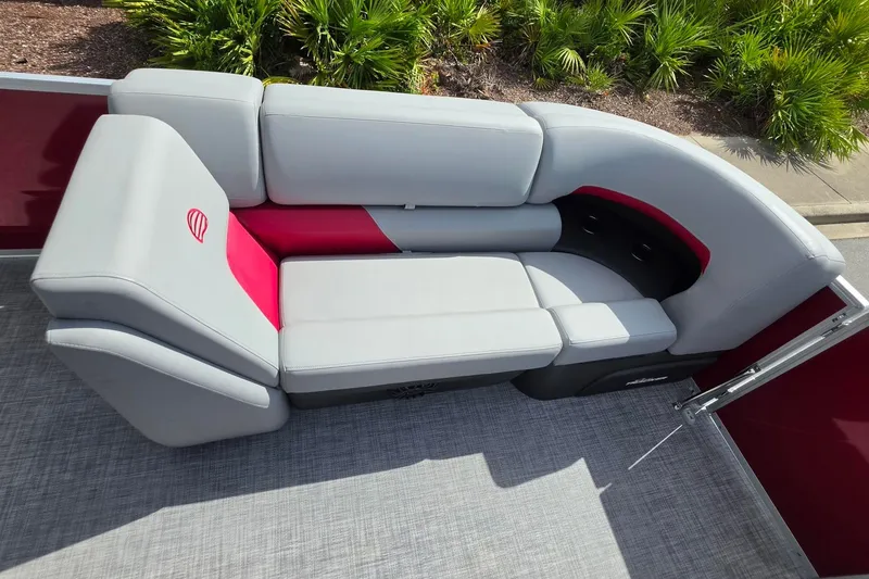 Slide: The Image of 2027 Sun Tracker Party Barge 20 DLX pontoon boat seating, featuring gray and red upholstery. - 16