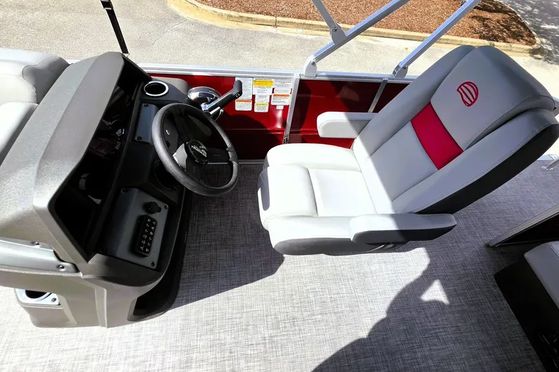 Slide: The Image of 2027 Sun Tracker Party Barge 20 DLX helm with steering wheel and captain's chair. - 13