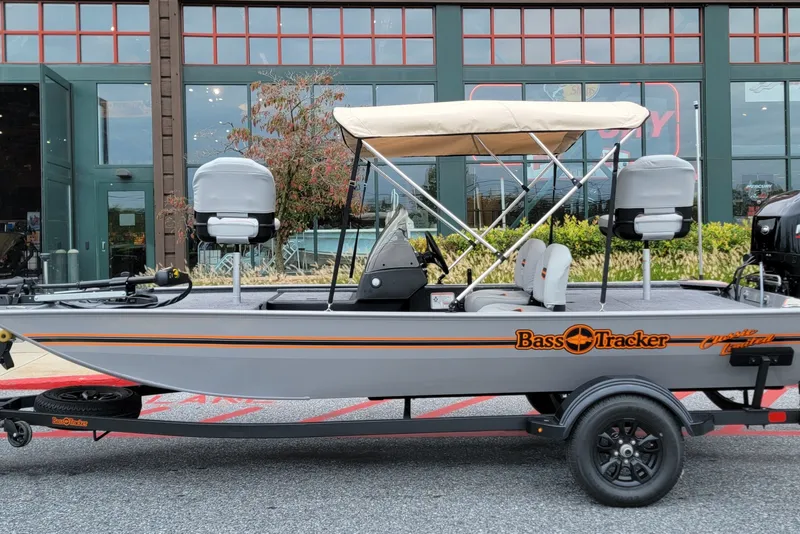 The Image of 2027 Tracker Bass Tracker Classic Limited boat with canopy, parked outside a store. - 0