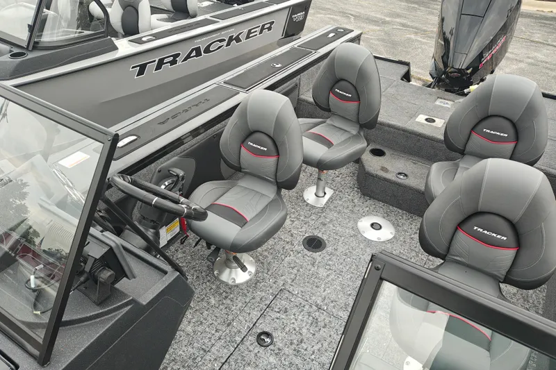 Slide: The Image of 2026 Tracker Targa V-19 WT boat interior with gray seating and steering console. - 39