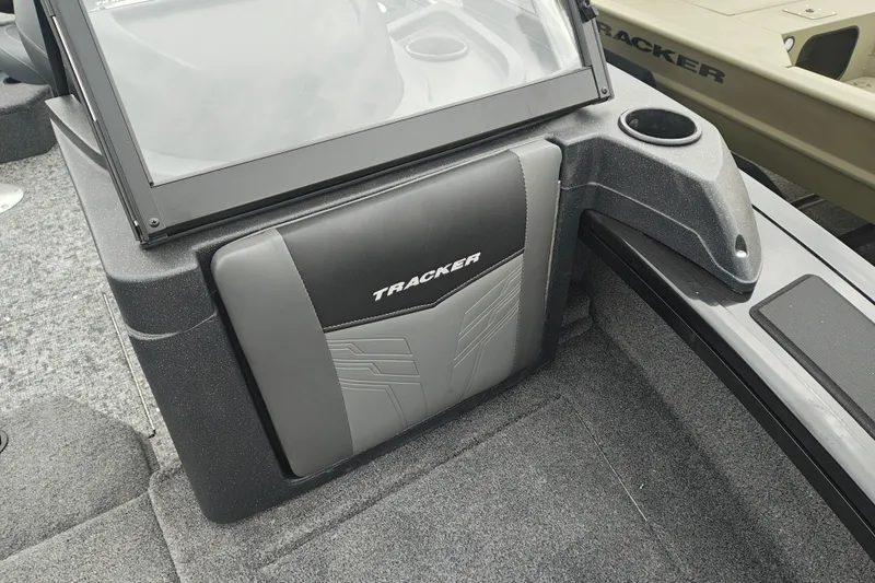 Slide: The Image of 2026 Tracker Targa V-19 WT boat interior with cup holder and logo detail. - 36