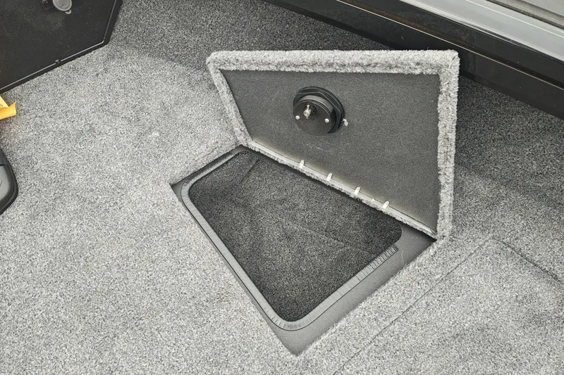 Slide: The Image of Open storage compartment in 2026 Tracker Targa V-19 WT boat, carpeted interior. - 31