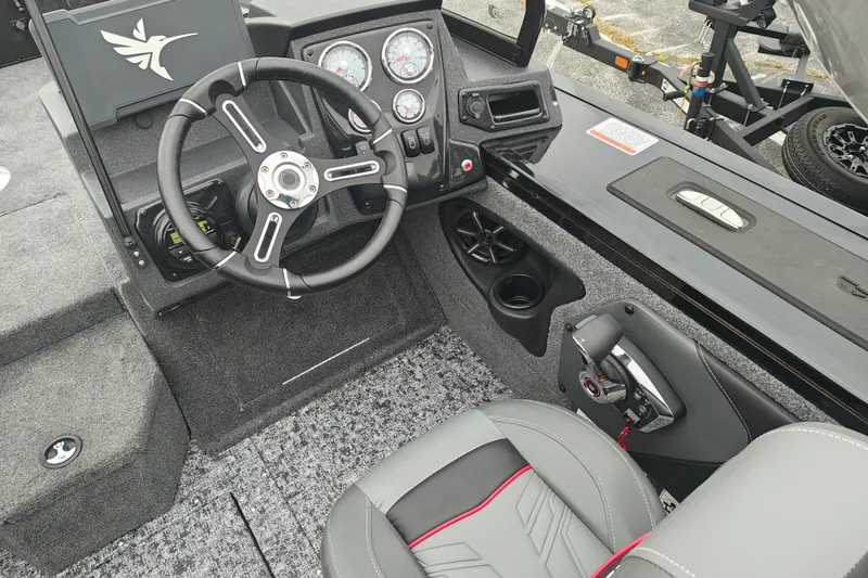 Slide: The Image of 2026 Tracker Targa V-19 WT boat interior with steering wheel and control panel. - 13