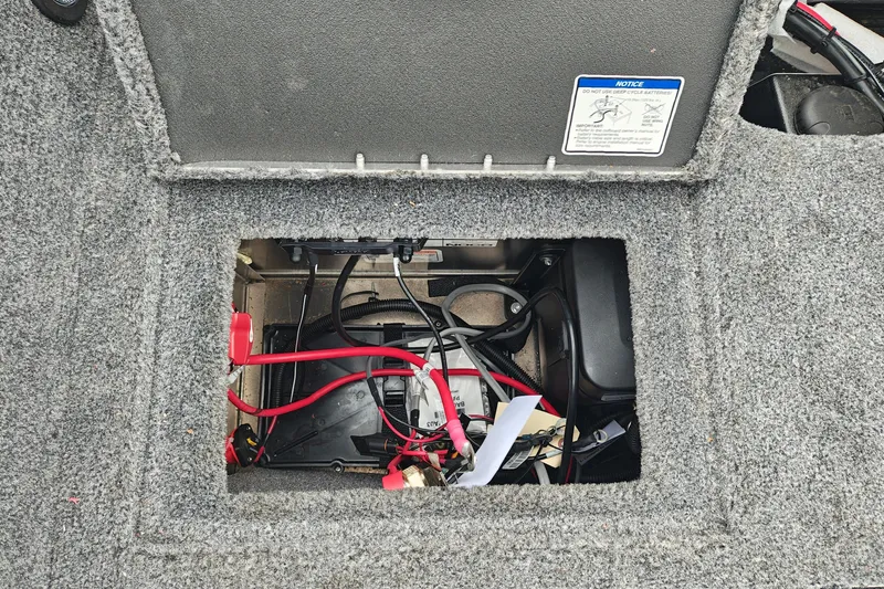Slide: The Image of Open battery compartment of 2026 Tracker Targa V-19 WT boat, showing wiring and connections. - 45
