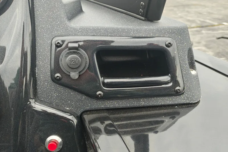 Slide: The Image of 2026 Tracker Targa V-19 WT boat dashboard with 12V marine power outlet. - 16