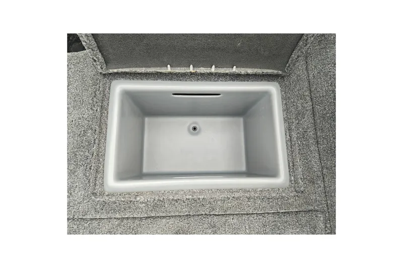 Slide: The Image of 2026 Tracker Targa V-19 WT boat storage compartment with gray interior. - 44