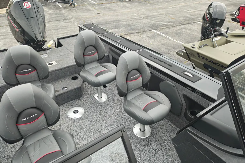 Slide: The Image of 2026 Tracker Targa V-19 WT boat interior with four gray seats and Mercury outboard motor. - 38