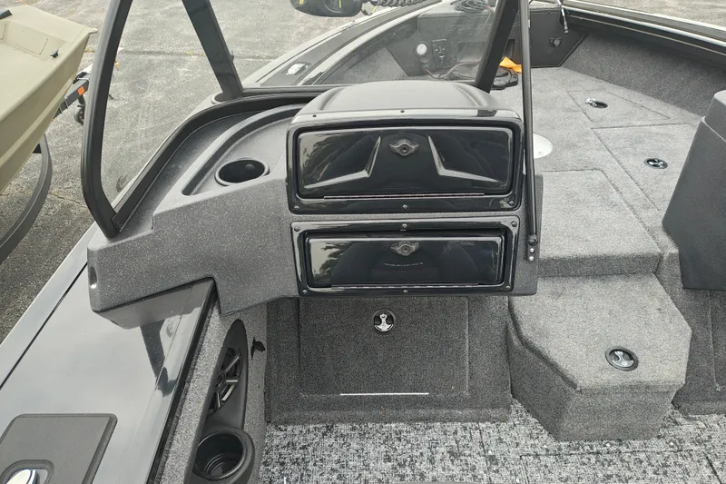 Slide: The Image of 2026 Tracker Targa V-19 WT boat interior with storage compartments and carpeted flooring. - 25