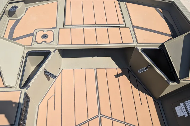 Slide: The Image of 2027 Tracker Grizzly 1553 Timber boat interior with storage compartments and non-slip flooring. - 14