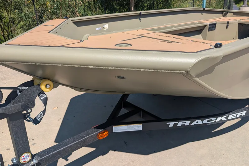The Image of 2027 Tracker Grizzly 1553 Timber boat on trailer, outdoors in sunlight. - 0
