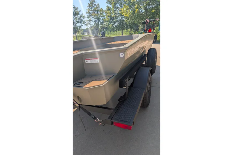 Slide: The Image of 2027 Tracker Grizzly 1553 Timber boat on trailer, parked outdoors. - 19