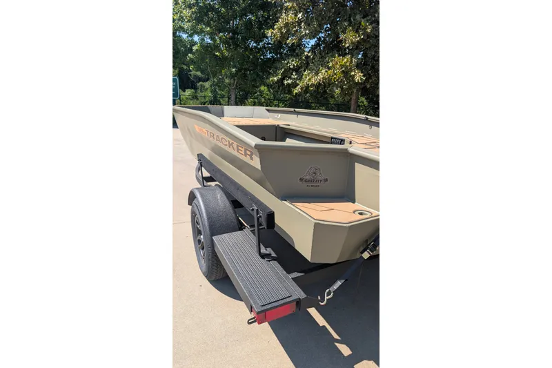 Slide: The Image of 2027 Tracker Grizzly 1553 Timber boat on trailer, parked outdoors. - 17