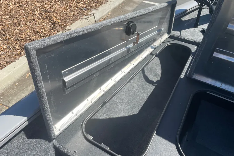 Slide: The Image of Open storage compartment in 2027 Tracker Pro Team 175 boat. - 14