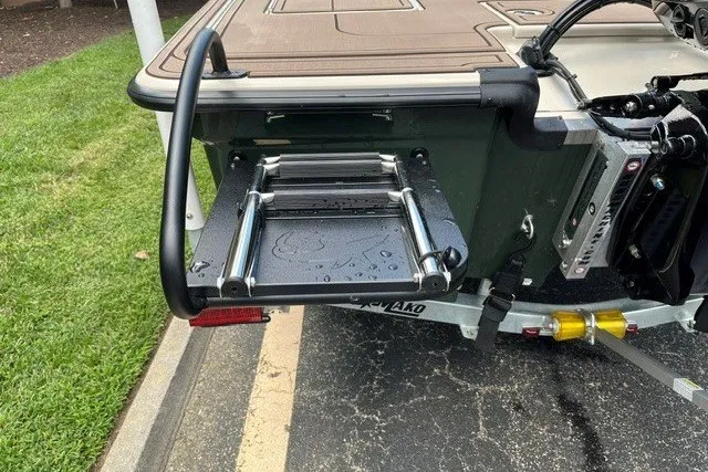 Slide: The Image of Rear view of 2026 Mako 18 Pro Skiff Backwater Edition with ladder and motor details. - 18