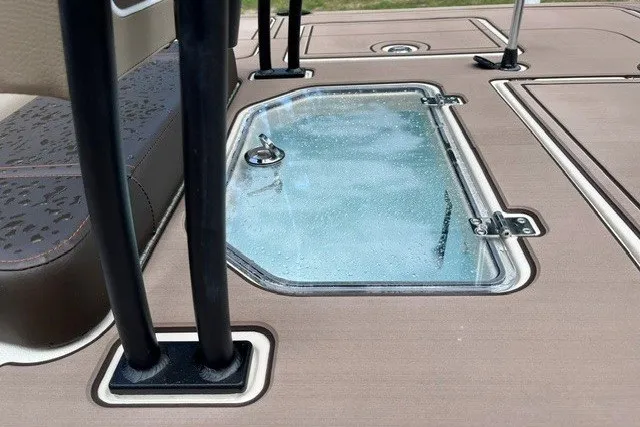 Slide: The Image of 2026 Mako 18 Pro Skiff Backwater Edition deck with water droplets on glass hatch. - 13