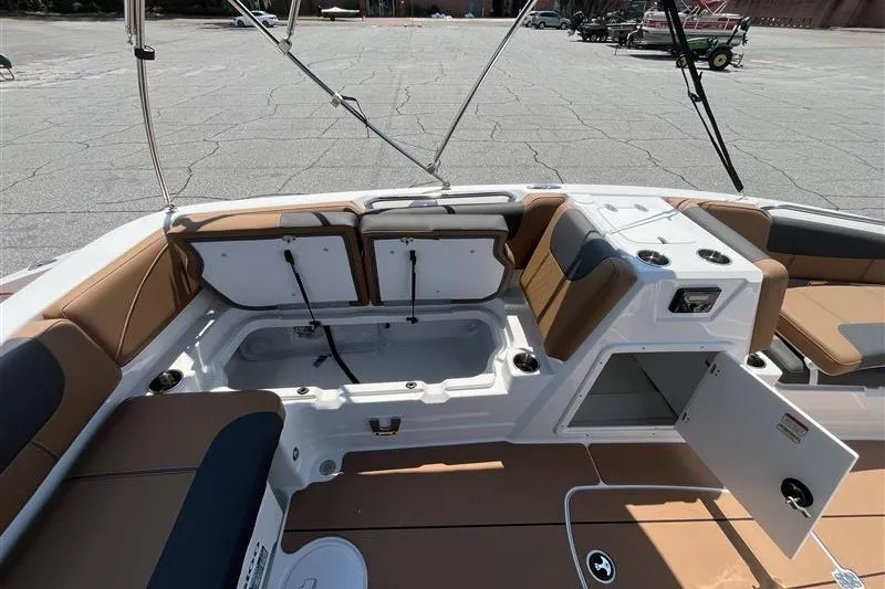 Slide: The Image of 2026 Tahoe 1950 boat interior with open storage compartments and seating. - 13