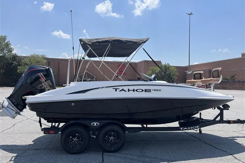 Slide: The Image of 2026 Tahoe 1950 boat on trailer, parked outdoors under clear sky. - 1