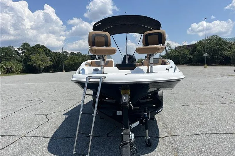Slide: The Image of 2026 Tahoe 1950 boat on trailer in sunny parking lot. - 5