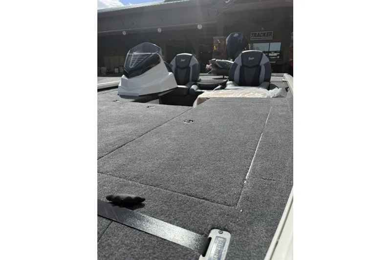 Slide: The Image of 2026 Ranger ALPHA 208 boat interior with cushioned seats and carpeted deck. - 11