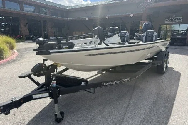 Slide: The Image of 2026 Ranger ALPHA 208 boat on trailer, parked outdoors near a building. - 1