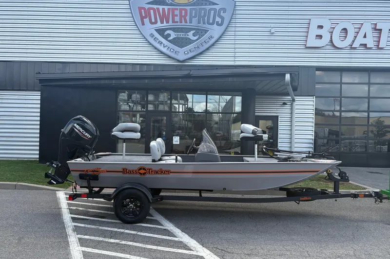 The Image of 2027 Tracker Bass Tracker Classic Limited boat on trailer outside service center. - 0