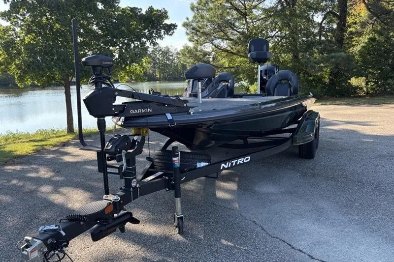 Slide: The Image of 2027 Nitro Z18 XL Pro fishing boat on trailer by a lake. - 13