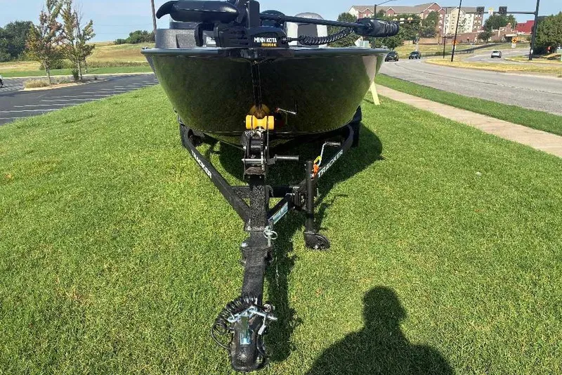 Slide: The Image of 2027 Tracker Pro Guide V-16 SC boat on trailer, parked on grass. - 13