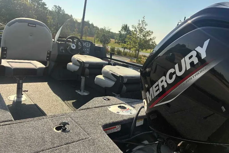 Slide: The Image of 2027 Tracker Pro Guide V-16 SC boat interior with Mercury engine, featuring seating and controls. - 18