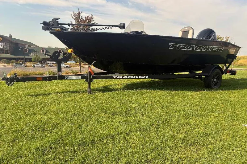 Slide: The Image of 2027 Tracker Pro Guide V-16 SC boat on trailer, parked on grass. - 15