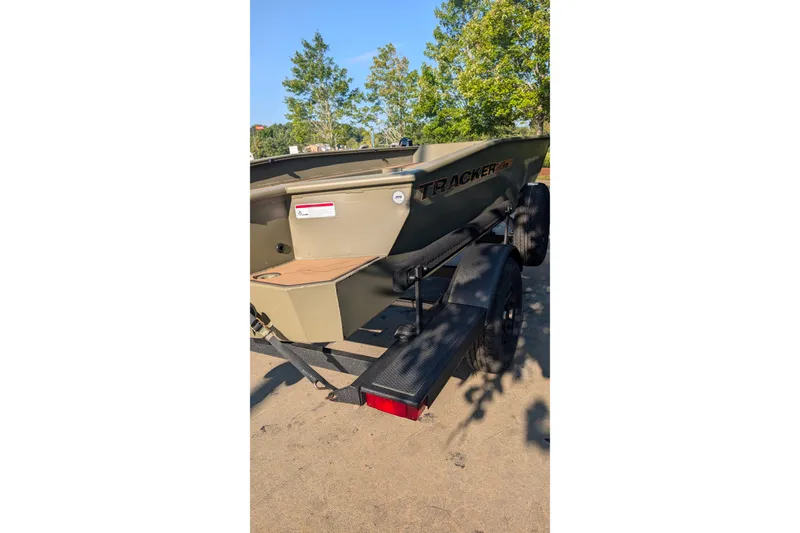 Slide: The Image of 2027 Tracker Grizzly 1553 Timber boat on trailer, parked outdoors. - 19