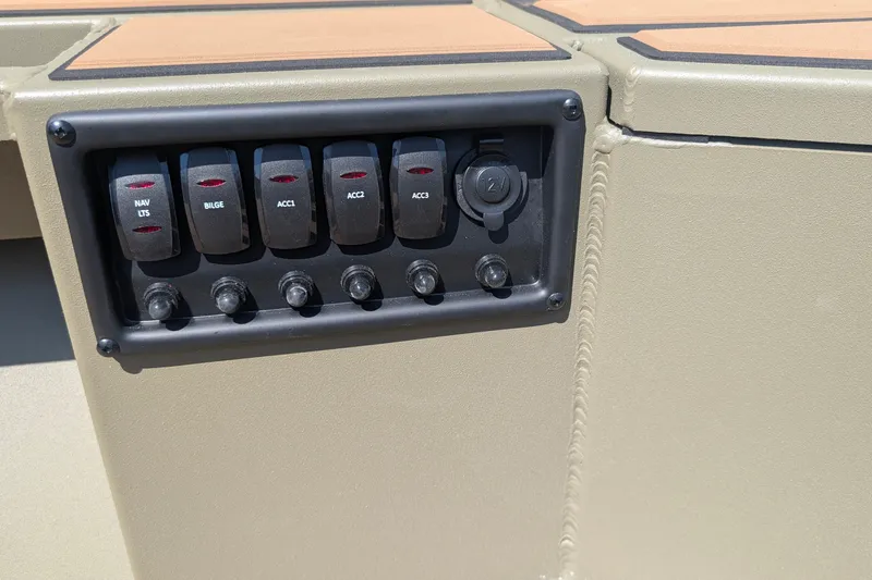 Slide: The Image of Control panel of 2027 Tracker Grizzly 1553 Timber boat with labeled switches. - 13