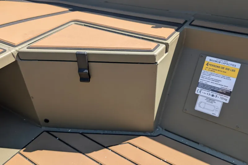 Slide: The Image of 2027 Tracker Grizzly 1553 Timber boat interior with storage compartment and capacity label. - 14
